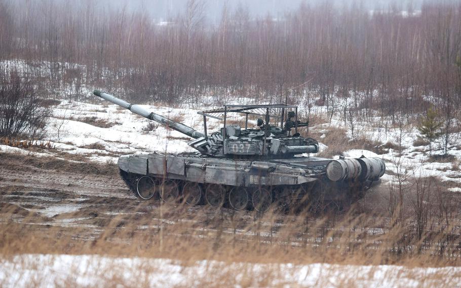 A tank moves along a field during joint exercises of the armed forces of Russia and Belarus as part of an inspection of the Union State's Response Force, at a firing range near the town of Osipovichi outside Minsk on Feb. 17, 2022. 