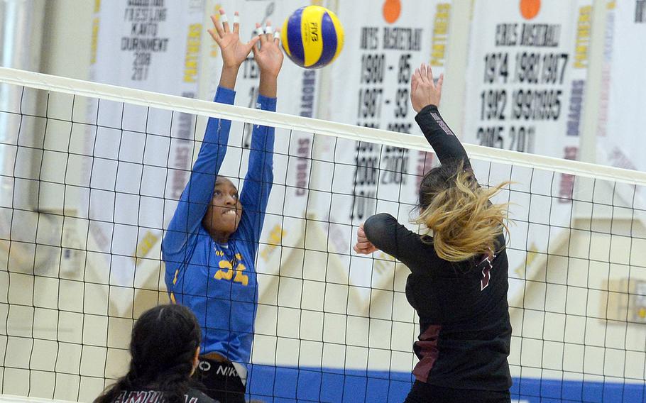 Yokota's Trinity Stegall reaches up to block a shot by Matthew C. Perry's Raelin Reyes during Saturday's DODEA-Japan volleyball match. The Panthers won in four sets.
