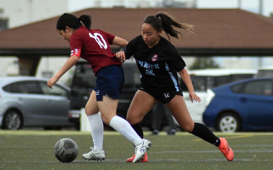 Ella Cala and Remi Suzuki battle for the ball.