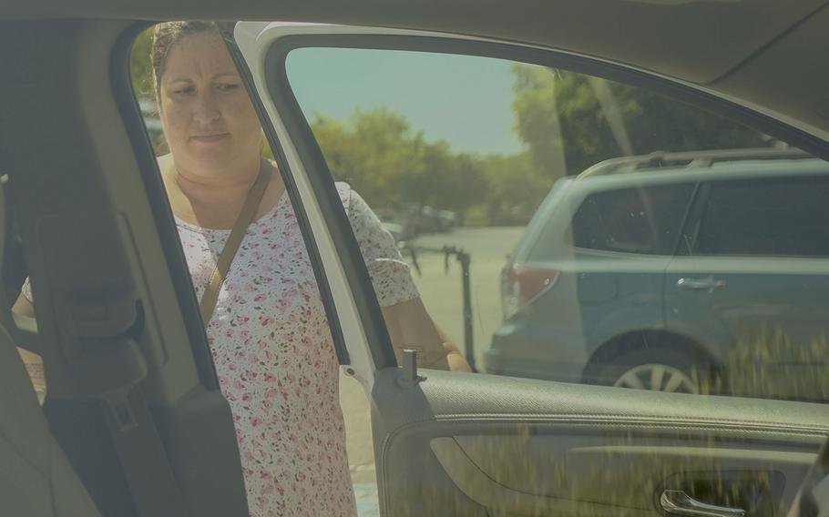 Wendy Latella gets into her car after running errands around Fredericksburg, Va.