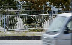 Fence damage from a fatal weekend collision is seen outside Camp Foster, Okinawa, Tuesday, May 10, 2022. 