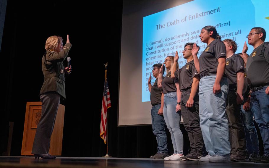 Gen. Laura Richardson, commander of U.S. Southern Command, administers the oath of enlistment to 16 new Army recruits in Northglenn, Colo., on April 27, 2023. An alumna of Northglenn High School, Richardson was on hand to tell students about the benefits of military service. A new Senate bill would allow recruiters greater access to high schools and colleges.