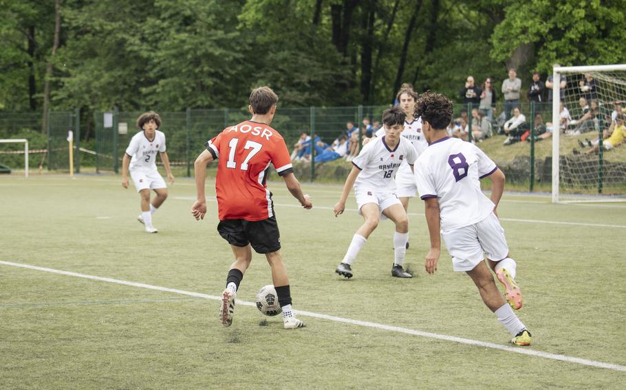 Orlando Niolu, a senior with the American Overseas School of Rome Falcons, attempts to break past the Bahrain Falcons' defense during the semifinals of the 2025 Division II DODEA European championships at Reichenbach-Steegen, Germany on May 21, 2025.