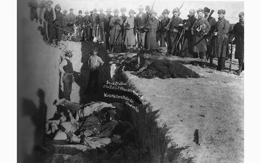 Burying the dead in a common grave at Wounded Knee, S.D., in the aftermath of the Dec. 29, 1890, battle.