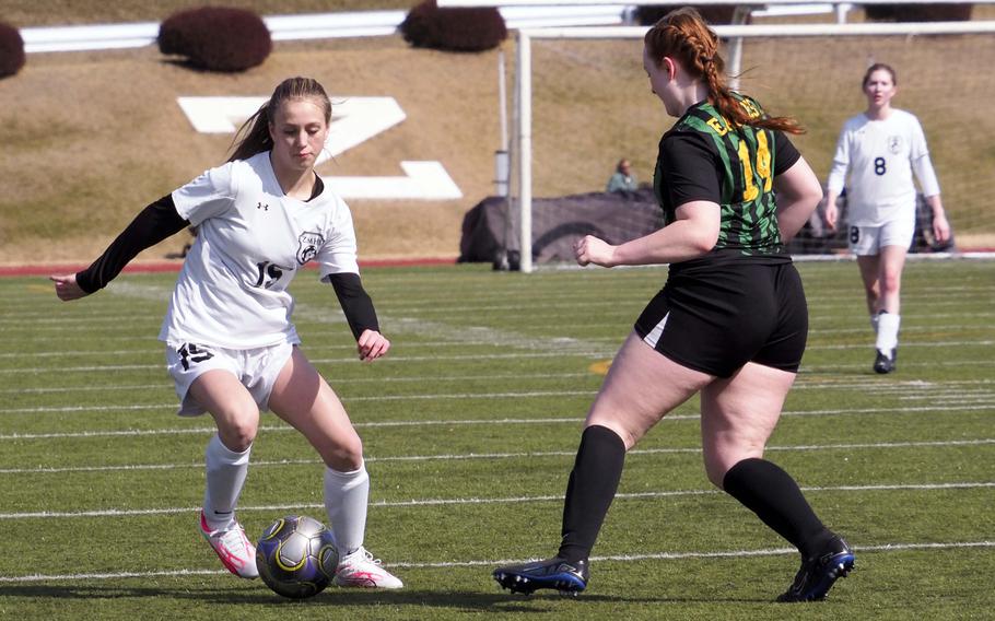 Zama’s Evelyn Schmidt tries to dribble past Robert D. Edgren’s Kyla Smith during Saturday’s DODEA-Japan girls soccer match. The Trojans won 2-1 to sweep the weekend series.