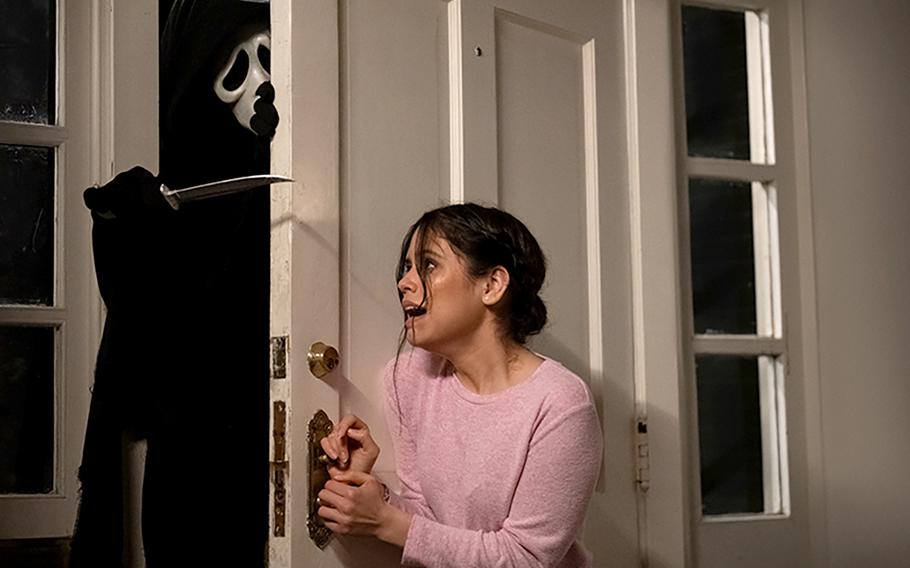 “Ghostface” and Jenna Ortega face off in “Scream,” which provides more meta-commentary on the horror film genre in the franchise’s fifth installment. 