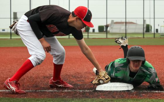 Kubasaki's Camden Fisk slides in safe at third base ahead of the tag by Kinnick's Aaden Otteson.