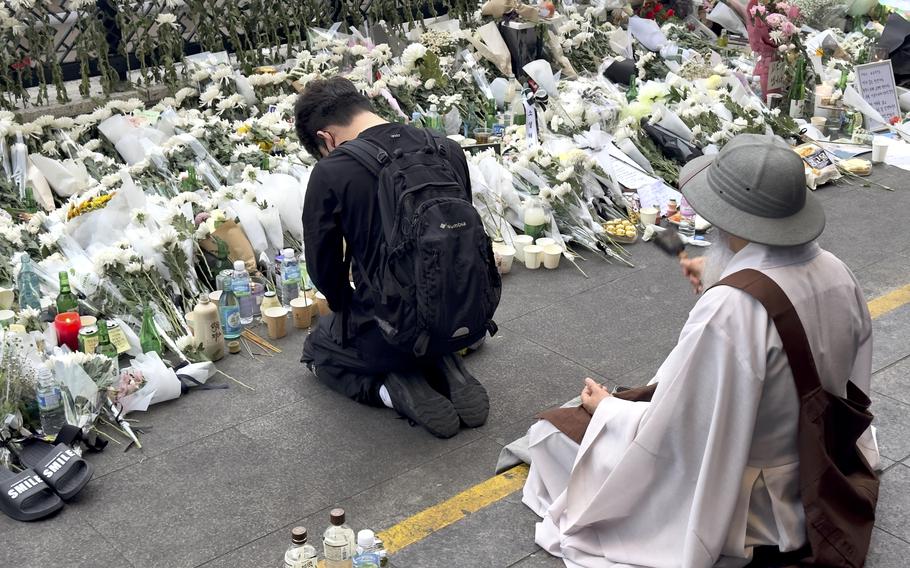 A mourner kneels at a memorial to surge victims in the Itaewon district of Seoul, South Korea, on Oct. 31, 2022. 