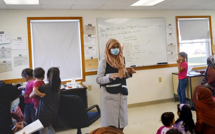 Afghan women and children learn English at Fort McCoy, Wis., on Sept. 28, 2021. The base has about 13,000 evacuees living in barracks while they await resettlement in the United States.