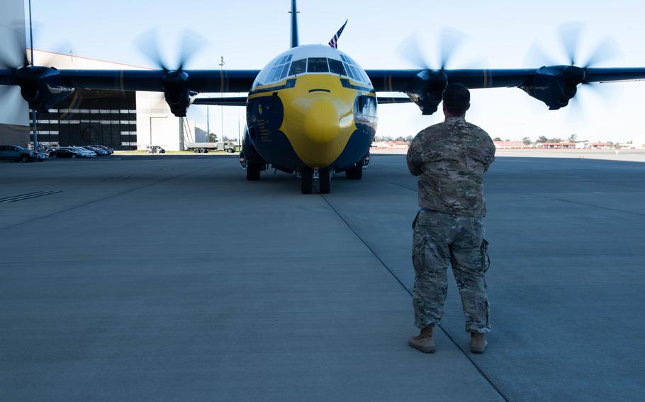 U.S. Air Force Master Sgt. Jeremy Powers, 660th Aircraft Maintenance Squadron KC-46 production superintendent, marshals the “Fat Albert” C-130J Super Hercules on the flight line at Travis Air Force Base, Calif., March 13, 2024. 