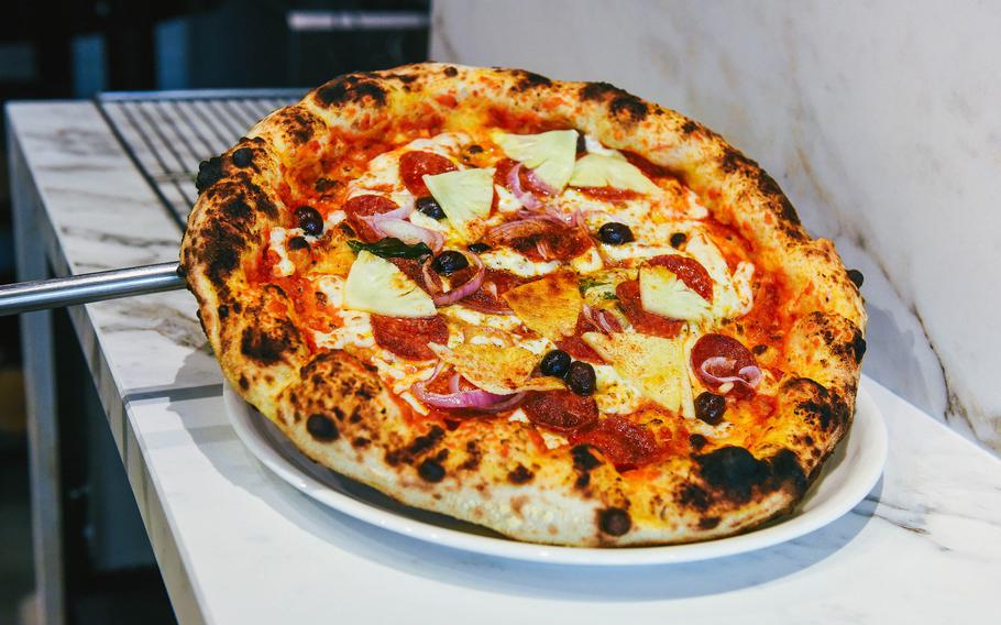 A pizza hot out of the oven is put on a plate.