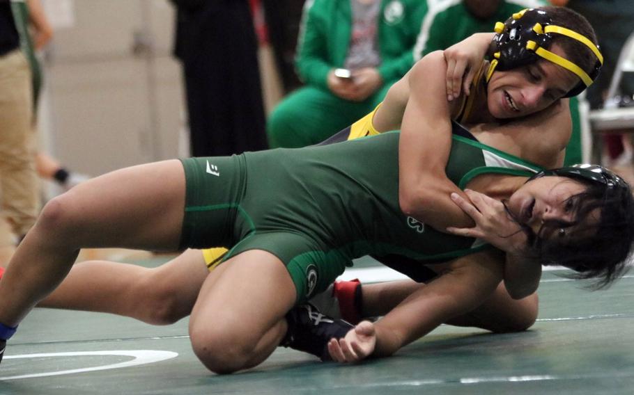 Kadena's Jayden Green gains the upper hand on Kubasaki's Gwen Panteleon at 101 pounds during Wednesday's Okinawa wrestling dual meet. Green won by technical fall 15-5 in 4 minutes, 59 seconds, and the Panthers won the meet 31-31 by virtual of more individual bouts won.