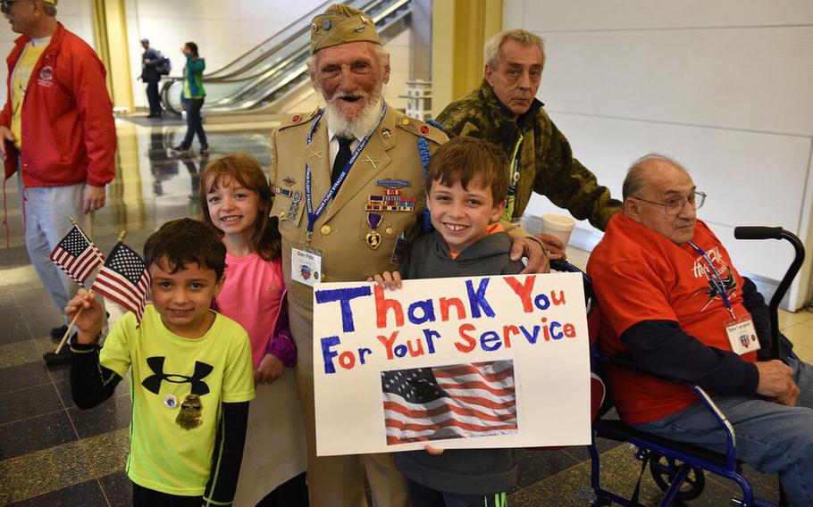 Donald D. Fida, 99, a World War II veteran and Central New York businessman, died at home on Tuesday, April 4, 2023.  Fida poses with welcoming children at Reagan National Airport as part of an Honor Flight in October 2015. 