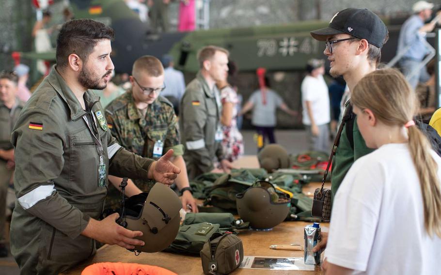 Visitors ask soldiers questions at German Armed Forces Day in Muenster, Germany, in 2023. A majority of Germans say they would be unwilling to fight for their country if it came under attack, according to a new poll. 