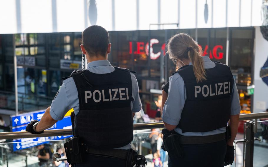 German police watch travelers in the terminal of Nuremberg's main train station May 29, 2023. The city has increased police patrols on weekends to counter high levels of crime at the station.