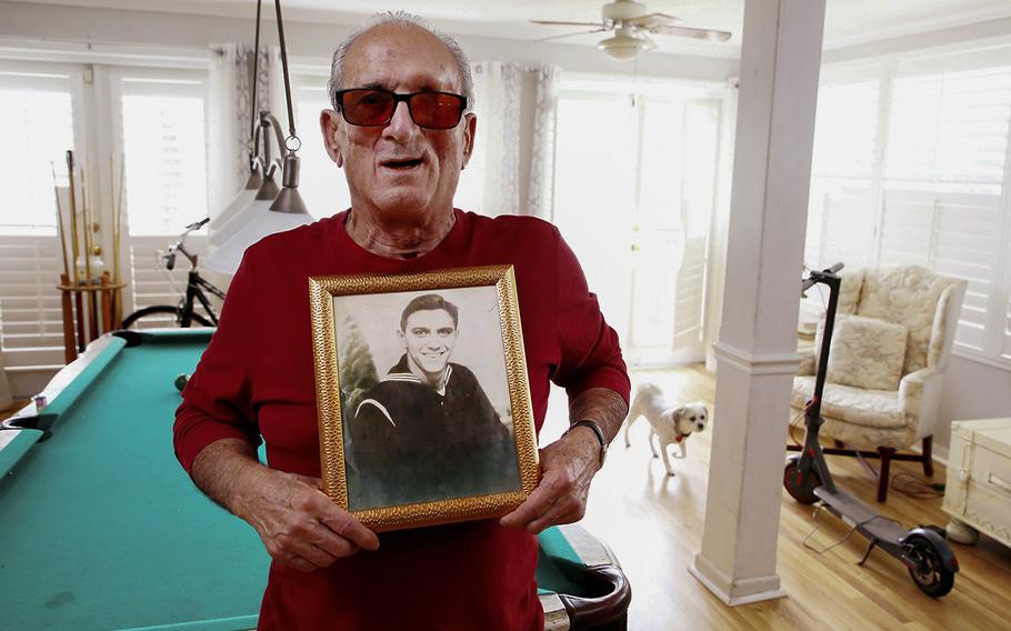 Convicted drug smuggler Angelo Bedami holds a photograph of his father Joe Bedami Sr., a mobster and alleged Santo Trafficante hitman. 