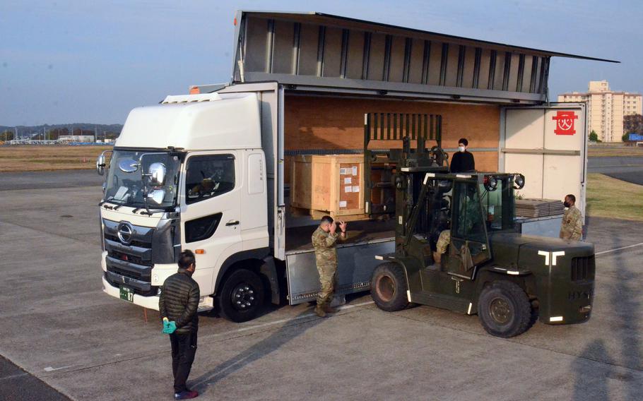 Airmen from the 374th Logistics Readiness and 730th Air Mobility squadrons help Japanese contractors load cargo bound for Misawa Air Base in northeast Japan onto a truck at Yokota Air Base in western Tokyo, Thursday, Nov. 18, 2021.