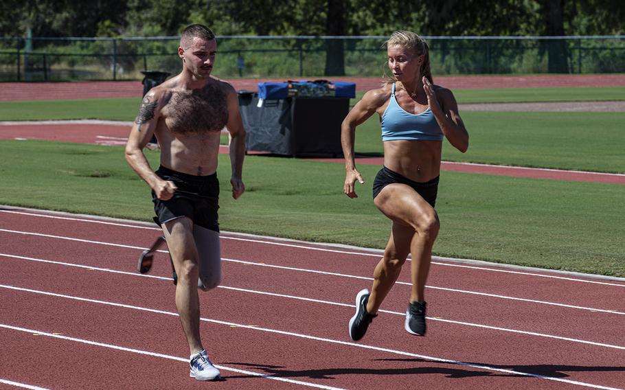 Ukranian service member Oleksiy Babchynets and Ukrainian head coach Olena Ianovska participate in a track and field practice at ESPN Wide World of Sports, Walt Disney World Resort, Orlando, Fla., during the 2022 Department of Defense Warrior Games, on Friday Aug. 19, 2022. 