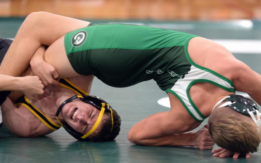 Kadena's Bruce Young uses a leg lace to tilt Kubasaki's Brady Potter at 135 pounds during Wednesday's Okinawa wrestling dual meet. Young won by technical fall 15-4 in 1 minute, 54 seconds, and the Panthers won the meet 30-27.