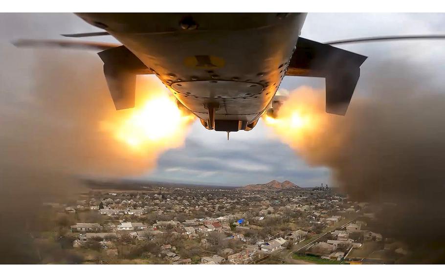 A screen grab from a video released on Friday, April 12, 2024, shows a Ka-52 helicopter gunship of the Russian air force firing rockets at a target at an unknown location in Ukraine. 