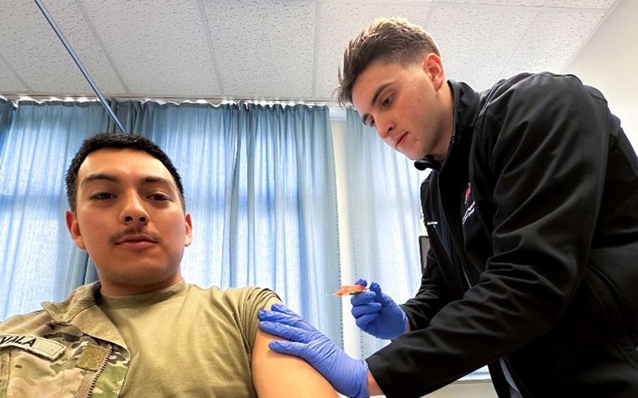 Airman 1st Class Kevin Donovan, an aerospace medical technician at Landstuhl Regional Medical Center in Germany, administers an influenza vaccine to Army Sgt. Jairo Zavala on Oct. 4, 2023.