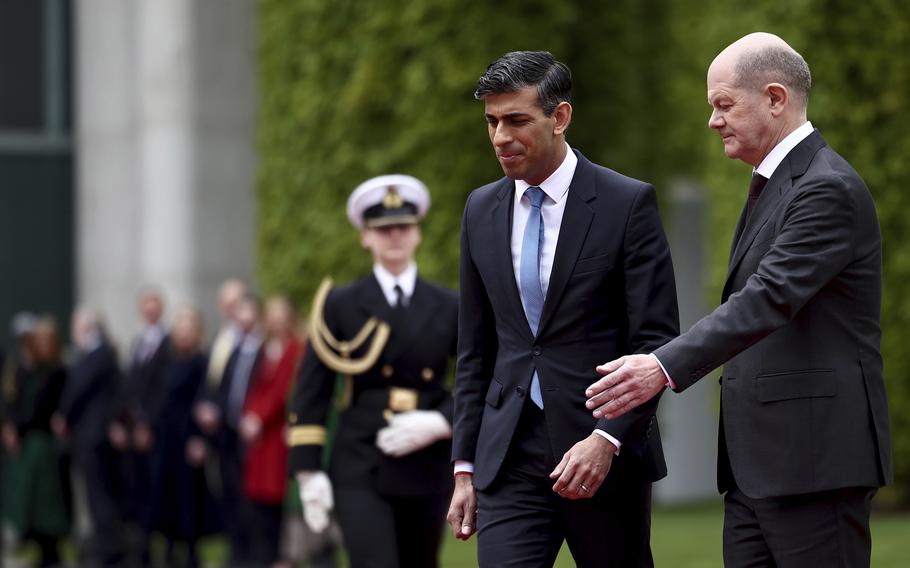 German Chancellor Olaf Scholz, right, and Britain’s Prime Minister Rishi Sunak review a military honor guard at the Chancellery in Berlin, Wednesday April 24, 2024.