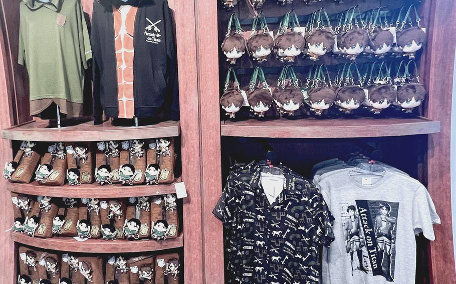 The "Attack on Titan" section at Universal Studios Japan in Osaka features a selection of souvenir merchandise. 