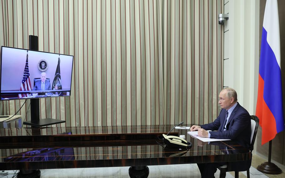 FILE - Russian President Vladimir Putin sits during his talk with U.S. President Joe Biden via video conference in the Bocharov Ruchei residence in the Black Sea resort of Sochi, Russia, Dec. 7, 2021. Biden warned Putin that Moscow would face “economic consequences like you’ve never seen” if it invades Ukraine, although he noted that Washington would not deploy its military forces there.