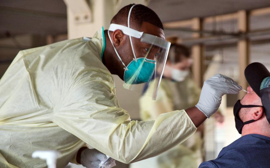 A member of the 51st Medical Operations Squadron tests a service member for coronavirus at Osan Air Base, South Korea, July 14, 2020. 