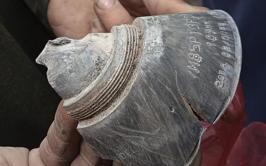 A local resident shows a piece of shell fired by Indian force