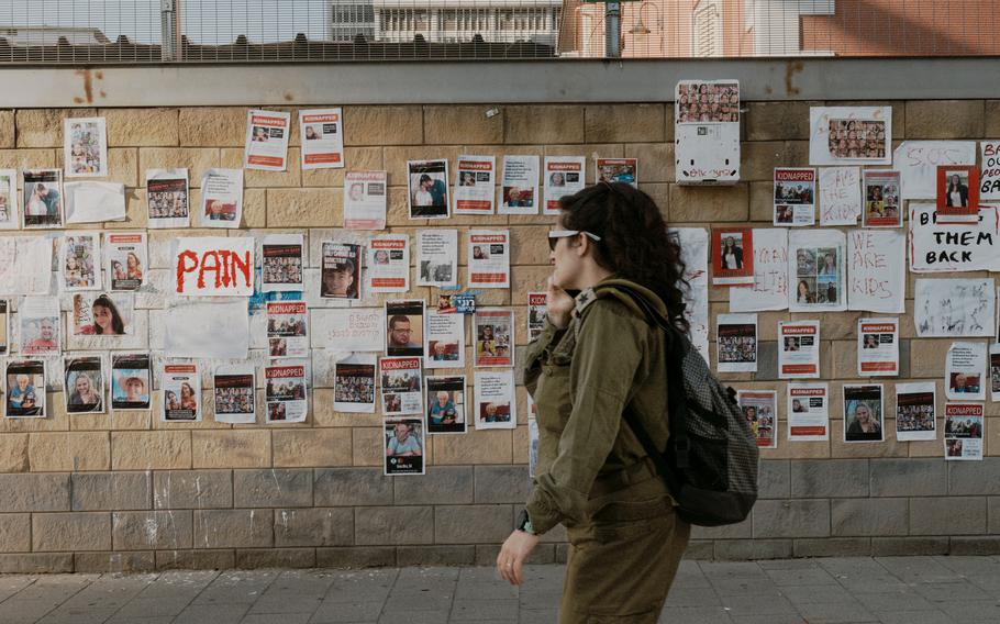 Photos and posters of Israeli hostages taken by Hamas and held in Gaza are seen on a wall in Tel Aviv on Oct. 18, 2023. 