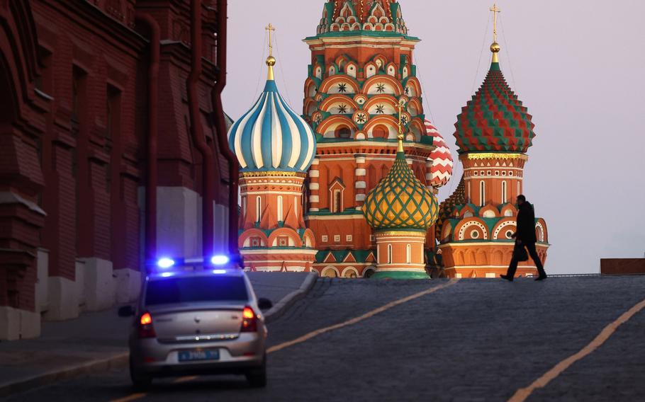 A police car patrols near Saint Basil’s Cathedral on Red Square in Moscow on Feb. 24, 2022.