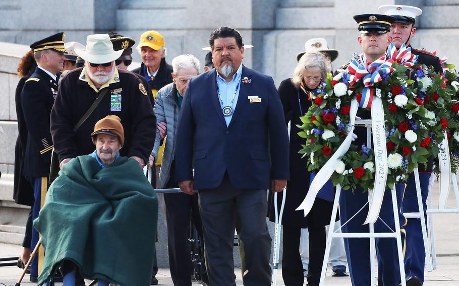 World War II veteran Marovelli and National Park Service Direcor Charles Sams III prepar to place the first wreath during the Veterans Day ceremony at the National World War II Memorial in Washington, November 11, 2023.