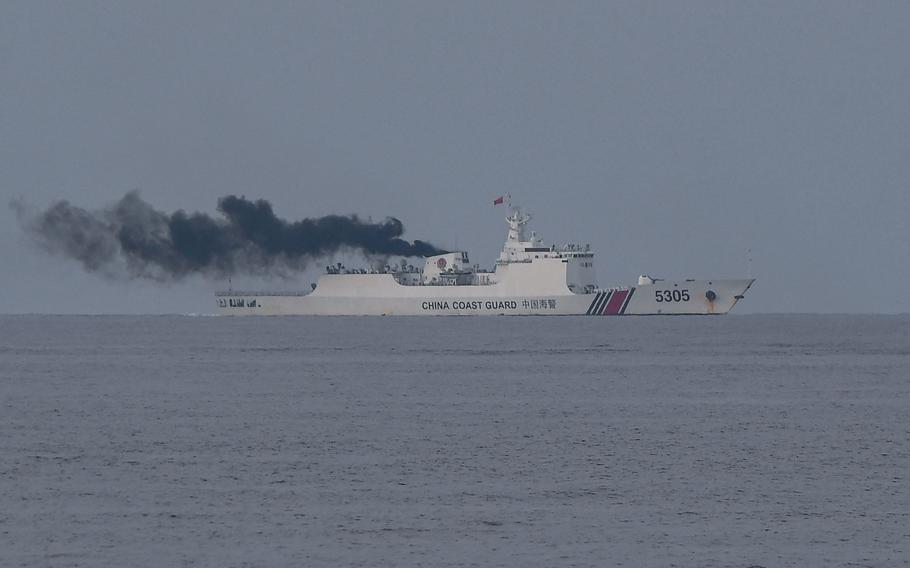 A Chinese coast guard ship shadows a Philippine coast guard ship in the disputed South China Sea, on Aug. 22, 2023.