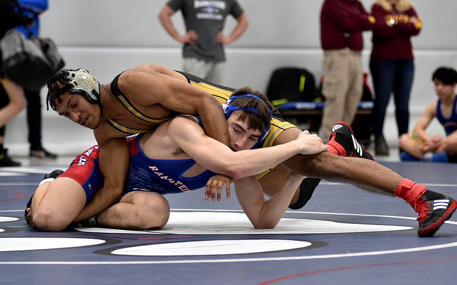 Stuttgart's Josiah Doughty and Ramstein's Hayden Bashman grapple during the 150-pound championship match at the DODEA Central sectional wrestling tournament on Saturday at Ramstein High School on Ramstein Air Base, Germany. Doughty defeate Bashman, 11-10.