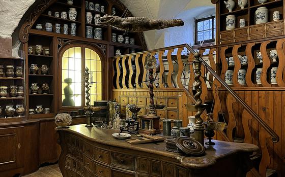 This room is a recreation of the officina for the Court Pharmacy of Bamberg in the Germany Pharmacy Museum in Heidelberg, Germany. The officina, or the Latin word for workshop, includes Baroque furnishings such as the preparation table from around 1730 to 1740.