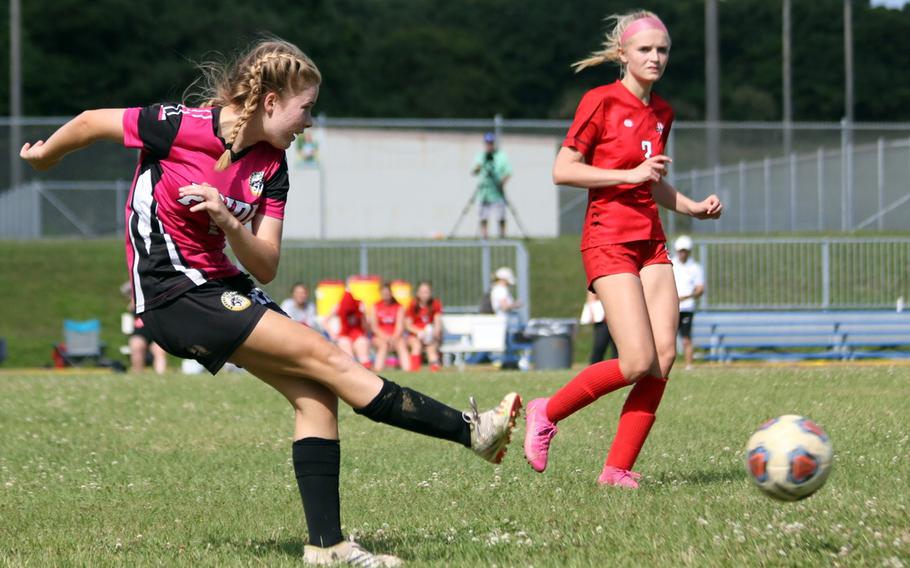 Kadena's Raegan Pellerin boots the ball against Nile C. Kinnick's Hailey Witt during Monday's Division I girls soccer match. The Panthers handed the Red Devils their first loss of the season 4-1.
