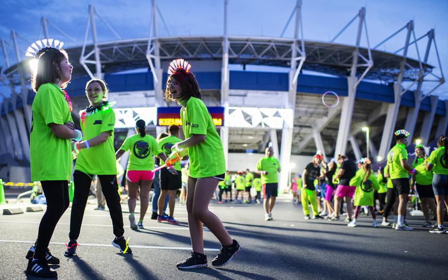 People gather for a neon fun run at Atago Sports Complex in Iwakuni city, Japan, Saturday, June 24, 2023.