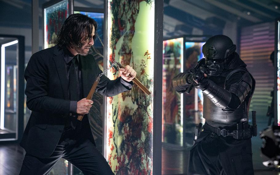 Keanu Reeves, left, stars in the violently bloody but exquisitely choreographed “John Wick: Chapter 4.” 