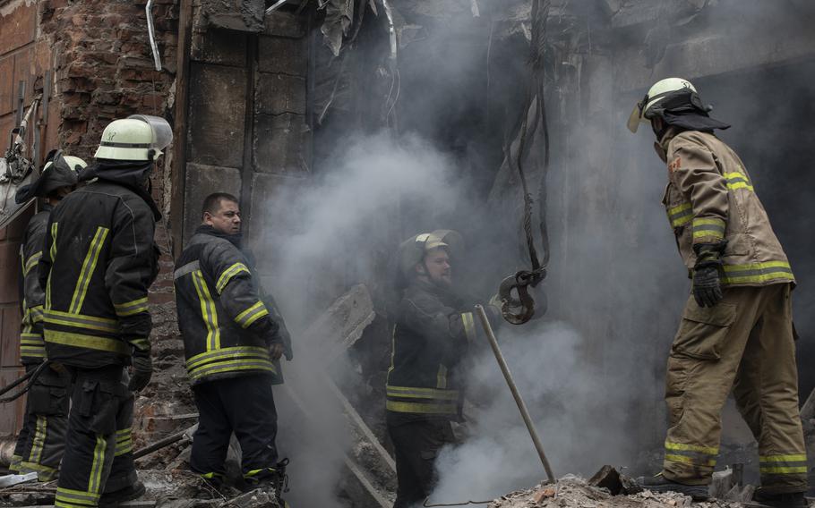 Serhii Moskalets, second from left, is the head of the rescue station in Sloviansk. He’s pictured with his fellow firefighters as they work on a heavily damaged building.