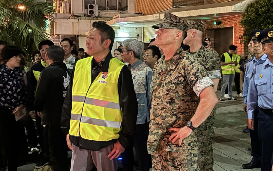 Maj. Gen. Brian Wolford, who’s in uniform, and Mayor Daisuke Hanashiro, who’s wearing a reflective vest, stand together. 