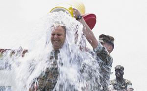 Marines dump water onto Col. Matthew Danner, commaner of the 31st Marine Expeditionary Unit, during a fundraiser at Camp Hansen, Okinawa, April 28, 2023. 