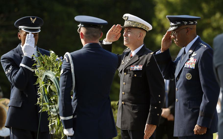 French Air and Space Force Chief of Staff Gen. Philippe Lavigne, center, and United States Air Force Chief of Staff Gen. Charles Q. Brown, right, salute Wednesday morning, July 7, 2021, after placing a wreath in front of the Yorktown Victory Monument.