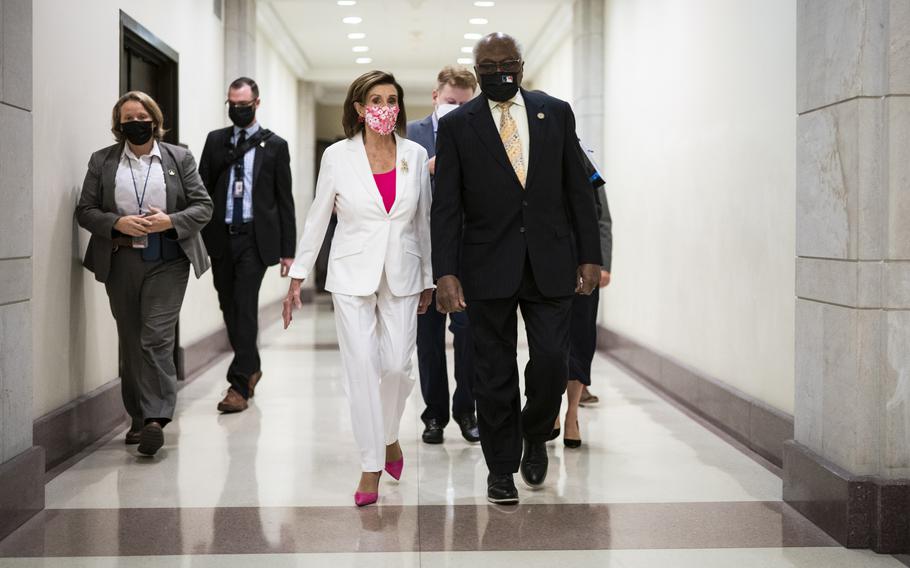 Speaker of the House Nancy Pelosi, D-Calif., walks with House Majority Whip James E. Clyburn, D-S.C., as they arrive for a news conference with Democratic leadership. 