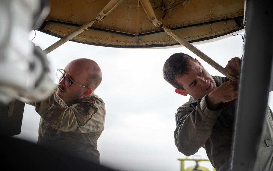 Airman 1st Class Steven Marshall, left, a crew chief for the 718th Aircraft Maintenance Squadron, and Maj. Myles Berthold, a 909th Air Refueling Squadron pilot, conduct preflight checks on a KC-135 Stratotanker at Kadena Air Base, Okinawa, May 23, 2023.