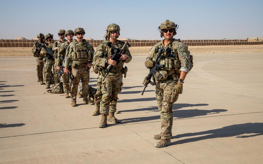 U.S. soldiers prepare to board a CH-47 Chinook helicopter during an exercise at al Asad Air Base in Iraq on July 7, 2023. The base was attacked Oct. 18, by one-way drones, which were shot down. The attack caused no injuries, according to the Pentagon.