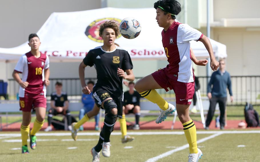 Matthew C. Perry's Eddie Pacleb tries to settle the ball in front of Yokota's Braedan Raybon during Wednesday's boys Division II playoff game. The Panthers won 3-0.