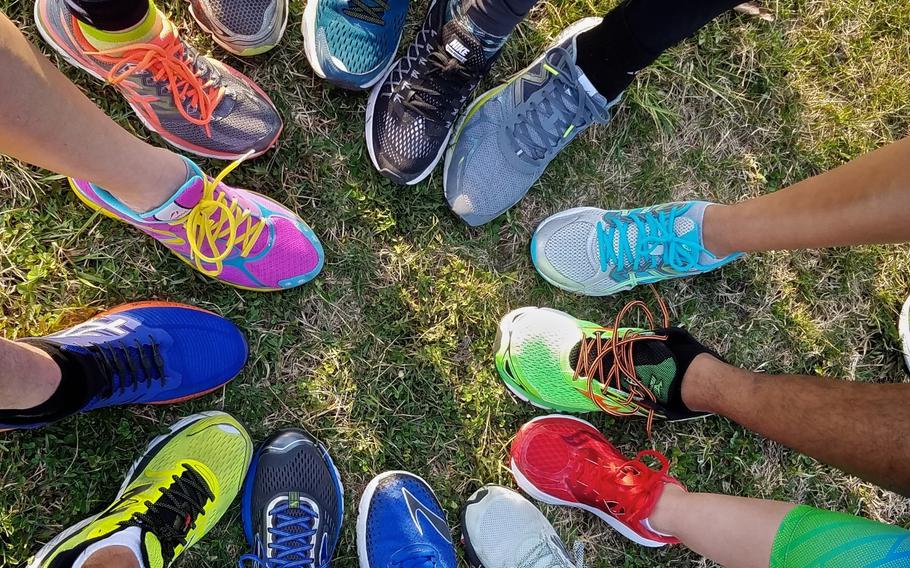 Runners show off their colorful running shoes.
