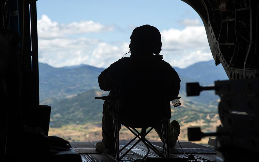 Army Staff Sgt. Nicholas Endres, a CH-47F Chinook flight engineer with 3rd Battalion, 25th Aviation Regiment, flies to Lal-lo Airport during Balikatan training in the Philippines on May 4, 2024.