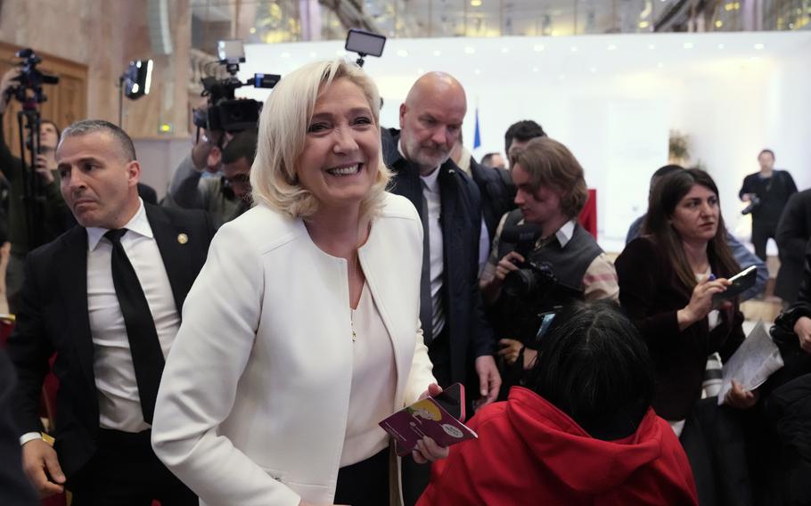 French far-right leader Marine Le Pen leaves after a press conference in Paris, Wednesday, April 13, 2022. 